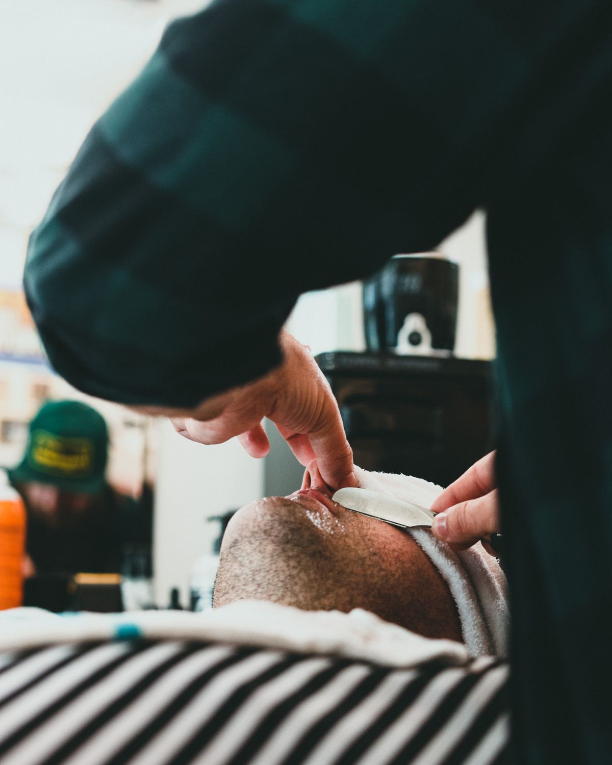 Barber giving a traditional straight-razor hot towel shave
